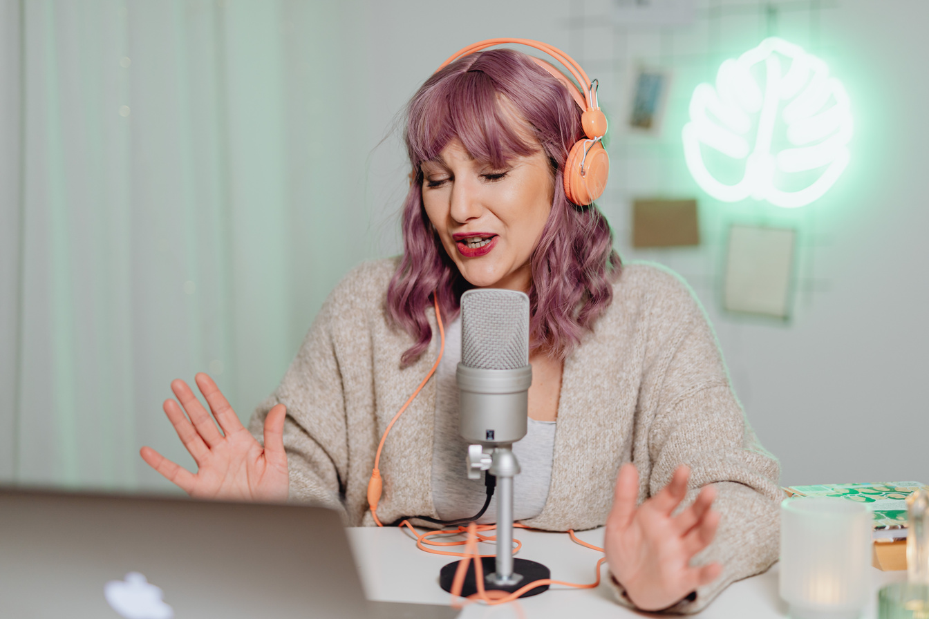 A Woman Talking on a Microphone while Wearing a Headset